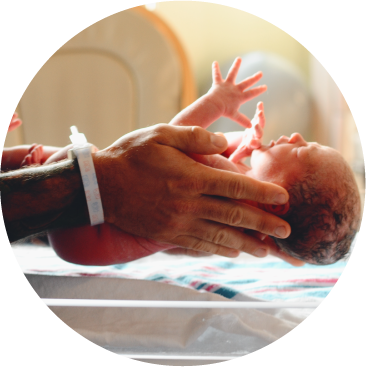 A newborn baby being held gently