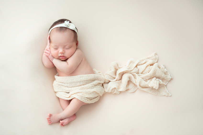 A sleeping newborn wrapped in a blanket